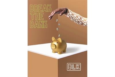 Hand dropping coins into golden piggy bank