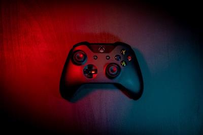 Xbox controller bathed in blue and red light
