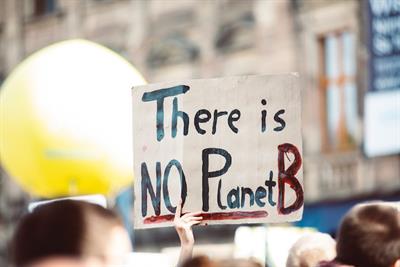 Climate protestors holding sign reading "There is NO Planet B"
