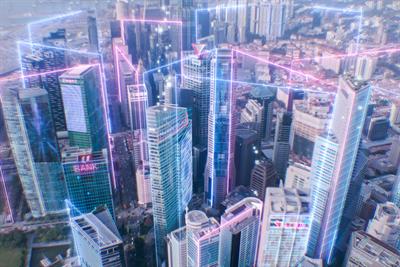 Aerial view of city with CGI network lines overlaid on top representing metaverse connectivity concept