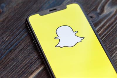 Snapchat ghost logo on smartphone screen.