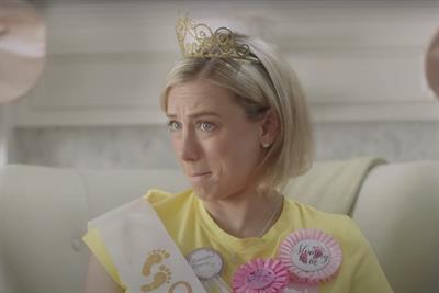 Screen shot from The Registry for More ad showing woman at baby shower wearing tiara