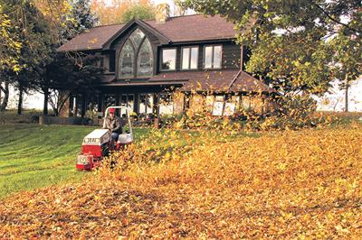 Leaf-clearance work: Ventrac 4500 compact tractor in use with blower attachment - image: Price Turfcare