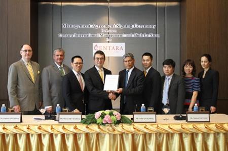 Hotel officials signing the agreement