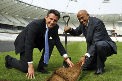 Seb Coe, chair of the London Organising Committee, and Olympian Frank Fredericks lay the final piece of turf at the Olympic stadium earlier this week.