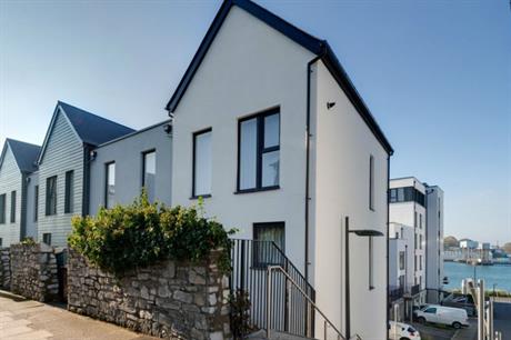 A limestone and granite wall forms the rear boundary to the housing (PIC HTA)