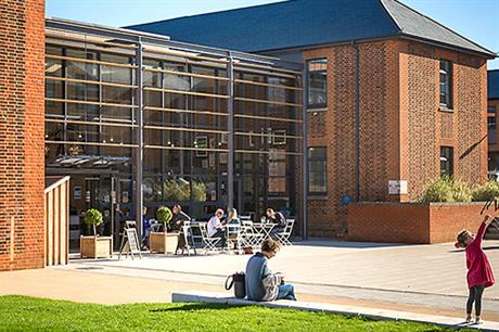 Two barrack buildings were reused for a small business centre and connected by a cafe with glass roof (PIC Architecture PLB)
