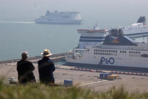 P&O Ferries ship with two onlookers viewing from a cliff