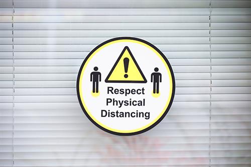 Sign saying 'respect physical distancing'