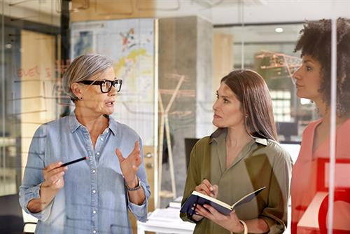 Woman aged over 50 talking to younger female employees