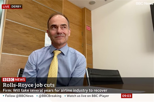 Rolls Royce ex-CEO smiling while delivering news of job cuts