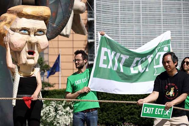 Environmental activists protest to call on EU leaders to exit the Energy Charter Treaty in Brussels in May (Photo by KENZO TRIBOUILLARD/AFP via Getty Images)
