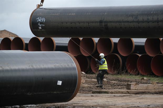 A worker at a pipe depot for the construction of the Eugal gas pipeline, March 2019 near Damerow, Germany. Photo: Sean Gallup/Getty Images