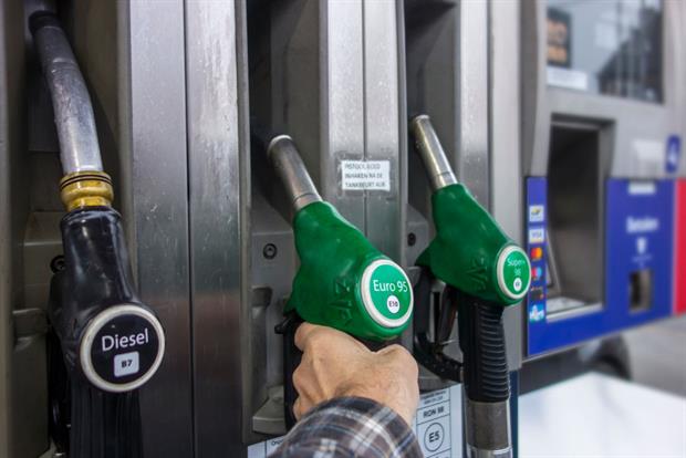 A car driver selects a fuel type at a petrol station: Research indicates that the EU transport sector receives billions of euros in fossil fuel subsidies each year. Photo: Arterra/Universal Images Group via Getty Images
