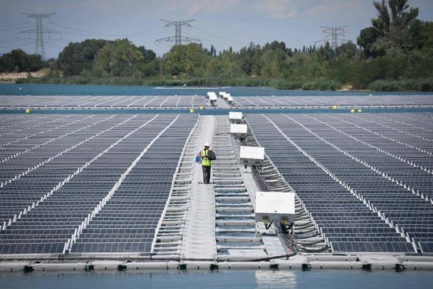 A technician walks on a floating solar farm in Piolenc, southern France, July 2019. The Commission has highlighted member states that are falling behind on renewables deployment. Photo: Gerard Julien/AFP via Getty Images