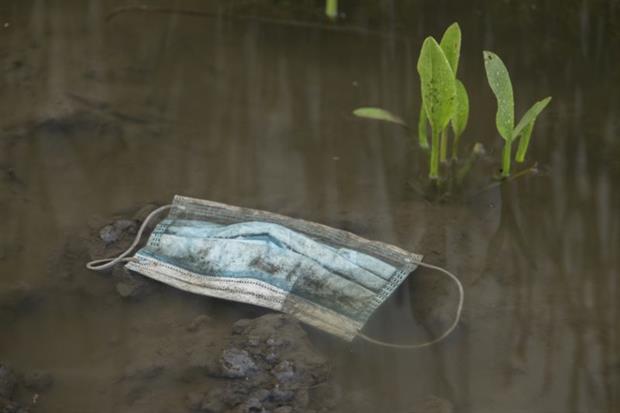Covid-19: A medical face mask floats in a puddle in the Odessa region of Ukraine. The pandemic has led to a spike in plastic pollution worldwide. Photograph: Andrey Nekrasov/Barcroft Media via Getty Images