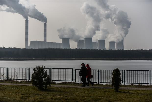 A couple walks past Poland's Belchatow power station, the world's largest lignite-fired plant. Campaigners have said member states are not ambitious enough in their approach to new emissions rules. Photo: Omar Marques/Getty Images