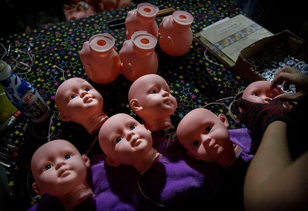 Plastic dolls being assembled. Cefic has warned that banned chemical DEHP frequently shows up in dolls imported from China. Photo: Kevin Frayer/Getty Images