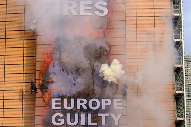 Greenpeace activists set off smoke flares in protest at ongoing damage to the Amazon rainforest (Photo by Thierry Monasse/Getty Images)