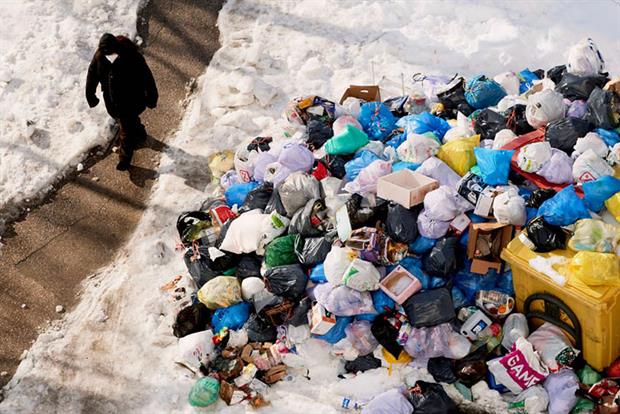 A man walks past accumulated rubbish in the streets of Madrid due to the snow caused by storm Filomena on January. Photo: Mariano Regidor/Getty Images