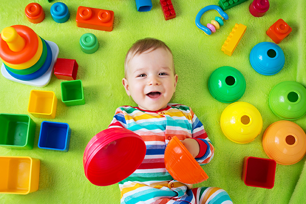 Plastics: child playing with plastic toys on rug. Photograph: Anna Grigorjeva/123RF