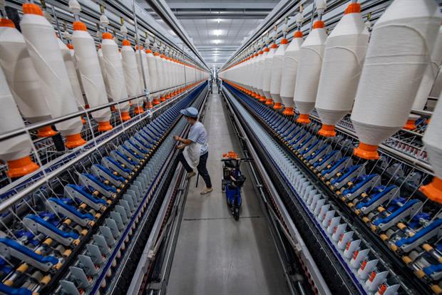An employee works at a textile factory in Baoji, Shaanxi Province of China, December 2020. Textiles sold in the EU have a major global footprint. Photo: Yuan Jingzhi/VCG via Getty Images