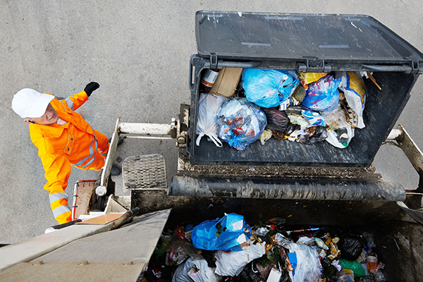 Waste: Municipal worker loads refuse vehicle (photograph: Dmitry Kalinovsky/123RF)