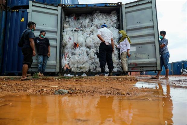 Indonesian officials check one of the 49 containers illegally loaded with garbage, plastic waste and hazardous materials from France and other developed countries, June 2019 on Batam island. Photo: Andaru/AFP via Getty Images