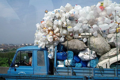 A truck laden down with products to be recycled travels along a highway in Shanghai (credit: Paul Louis / GNU FDL)