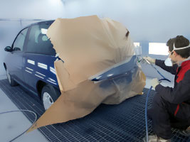 Man spray-painting a car