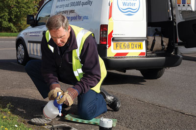 Thames Water employee checking a water meter