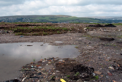 Trial pits dug by the Environment Agency at an illegal landfill site in Tredgegar, Blaenau Gwent, uncovered