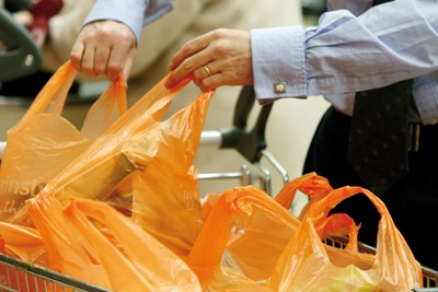 Single-use plastic bags being loaded into shopping trolly (picture: Sainsbury's)