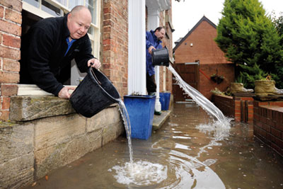 Residents near Stroud, Gloucestershire, bale out water during a 2008 flood: 5.2 million homes in England are at risk of flooding (photo: Adrian Sherratt/Alamy)