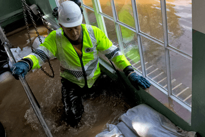Environment Agency officer in a flooded housed, Somerset 2012 (photograph: Environment Agency)