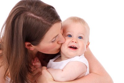 Mother kissing baby