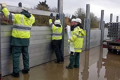 Environment Agency staff extending flood barriers along the river Severn, Bewdley (photograph: Dave Throup)