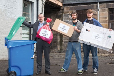 Recycling being placed into a bin. Credit: Zero Waste Scotland