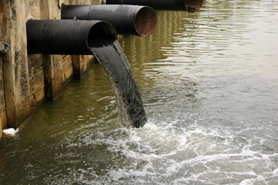 sewer pipe discharging into water