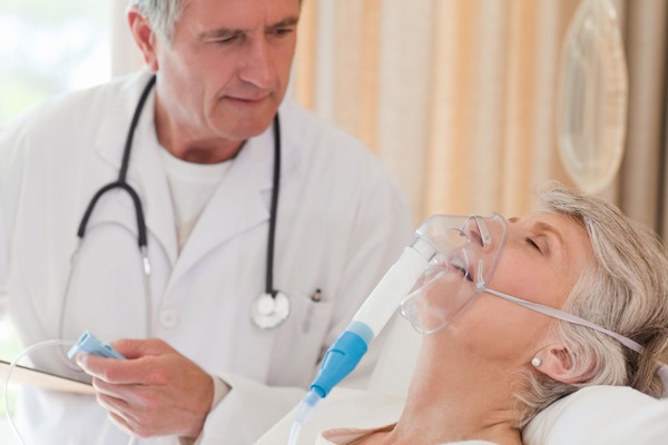 doctor examining patient with air mask
