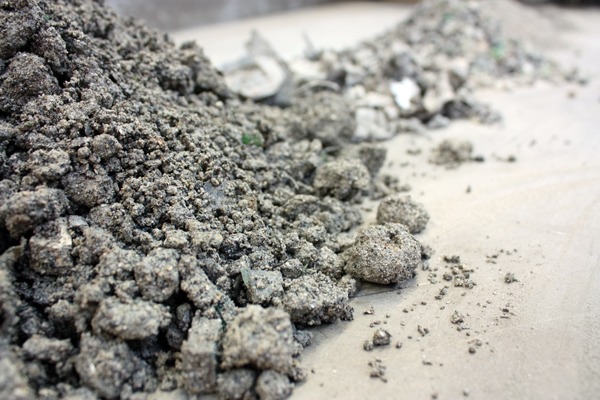 Incinerator bottom ash can contain fragments of many materials left after combustion, such as glass, and can be used as an alternative to aggregates. Photograph: ESG