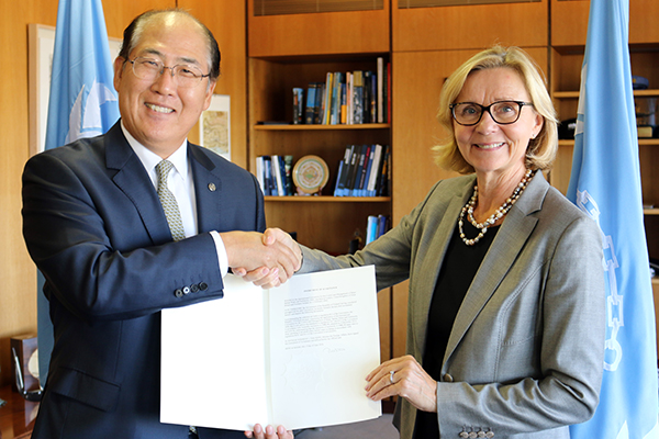 The Finnish ambassador hands over the country’s instrument of acceptance to the Ballast Water Management Convention to the IMO secretary general. Photograph: International Maritime Organization