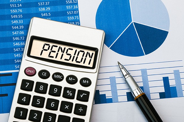 Calculator with pension on screen sitting on a graph