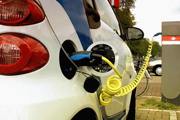 electric vehicle connected to charging point