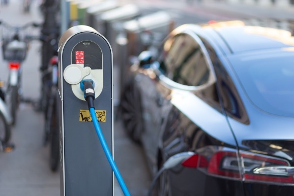 electric vehicles hooked up to charging points