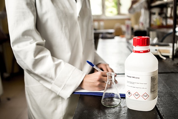 Scientist in lab coat recording chemical data. Photograph: Eldar Nurkovic/123RF