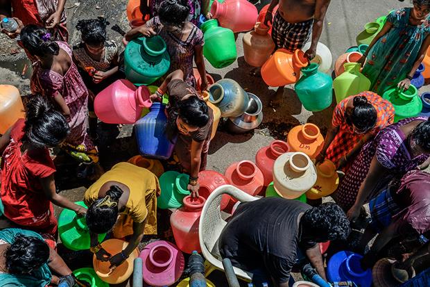 Chennai, India, 29 June 2019: People living in a slum settlement gather near a water tanker to collect their daily supply (photograph: Atul Loke/Getty Images)
