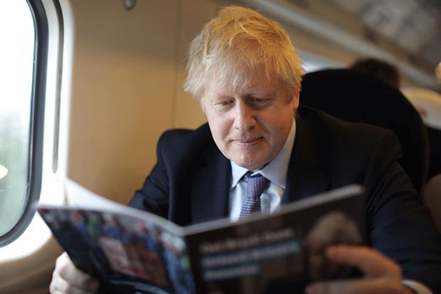 Prime minister Boris Johnson takes a read of his manifesto in preparation for its launch. Photograph: Dan Kitwood/Getty Images