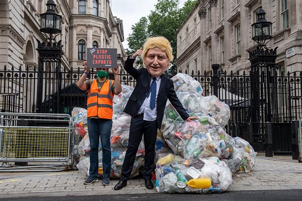 Greenpeace activists dump bags of plastic waste at the entrance to Downing Street in a protest against the UK governments exporting of plastic waste in July