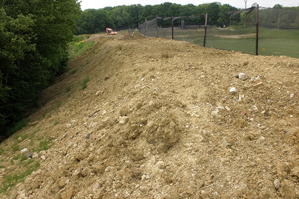 Bund created out of illegally deposited waste soil